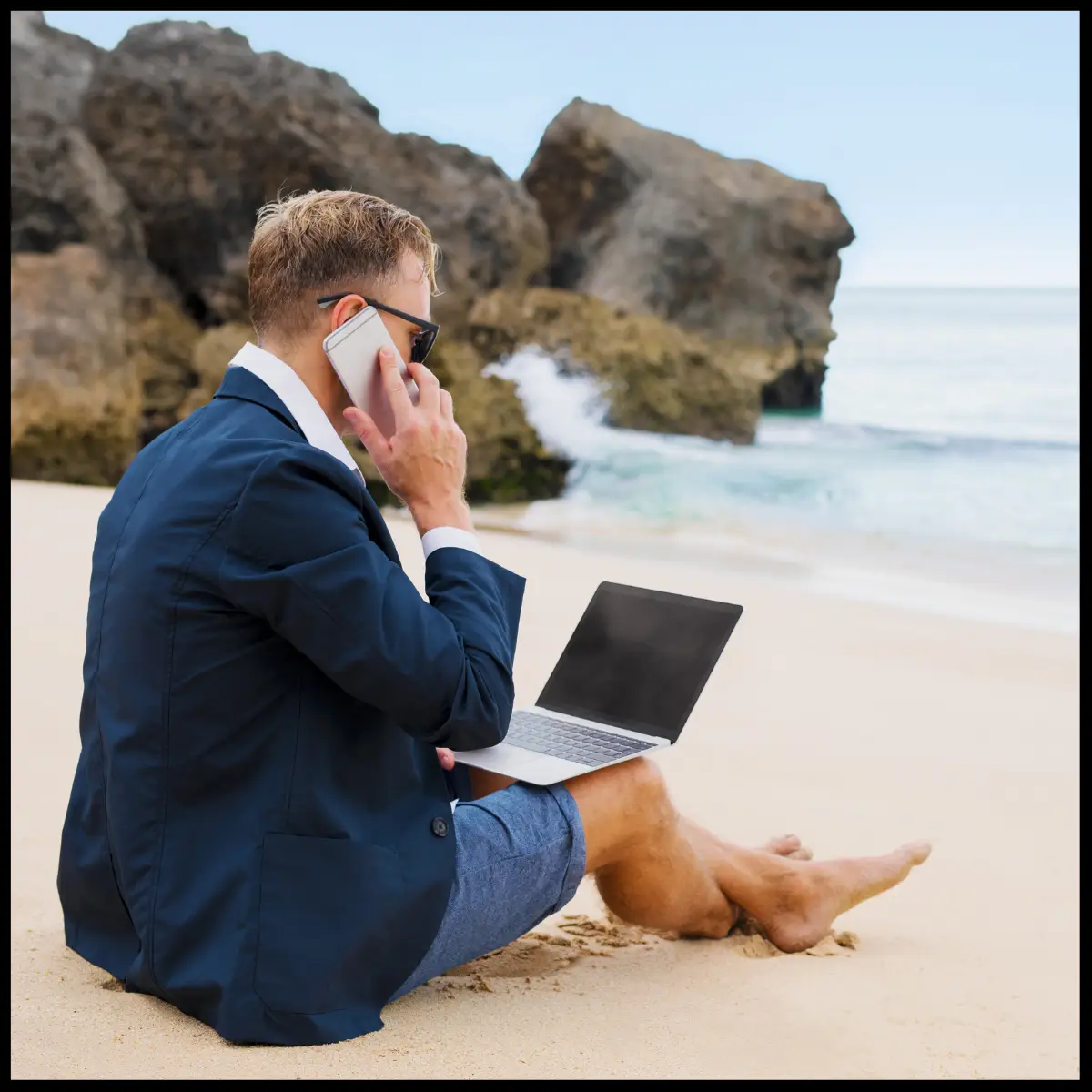 Professional working remotely on a laptop from a beach location